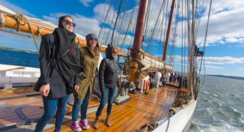 Passengers standing on the Bluenose II as it sails
