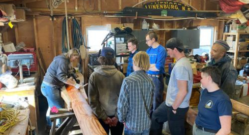 A group watching a demonstration at a workshop
