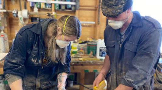 Two people working in a workshop