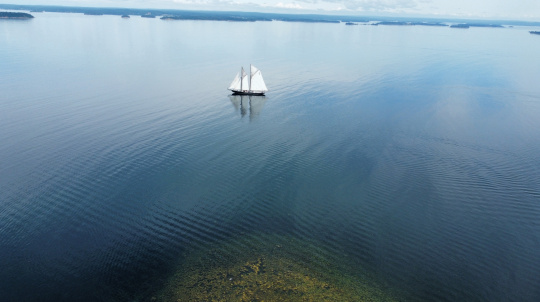 Bluenose II setting all eight sails in the Mahone Bay area.